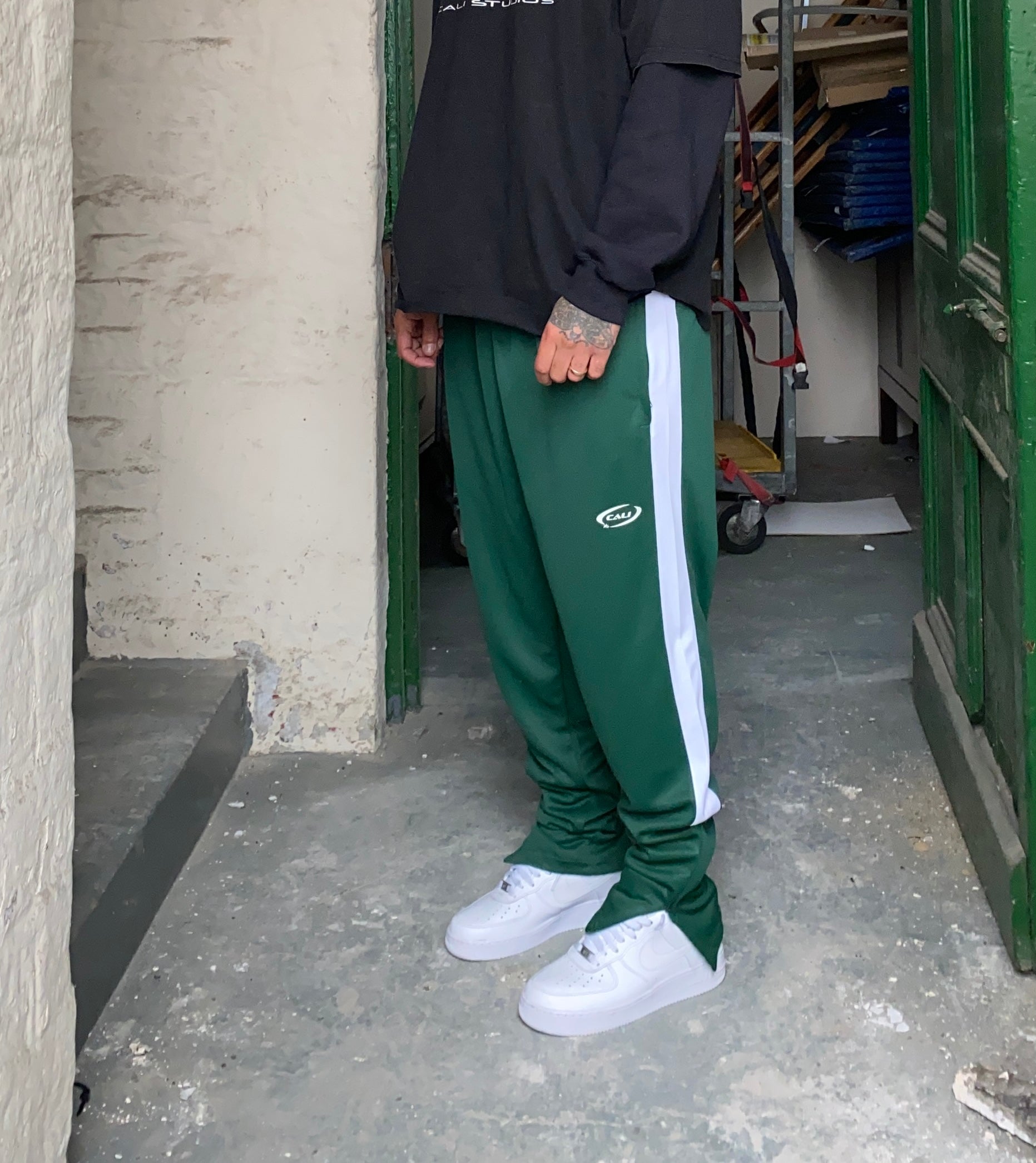 Green track pants hot sale with white stripe